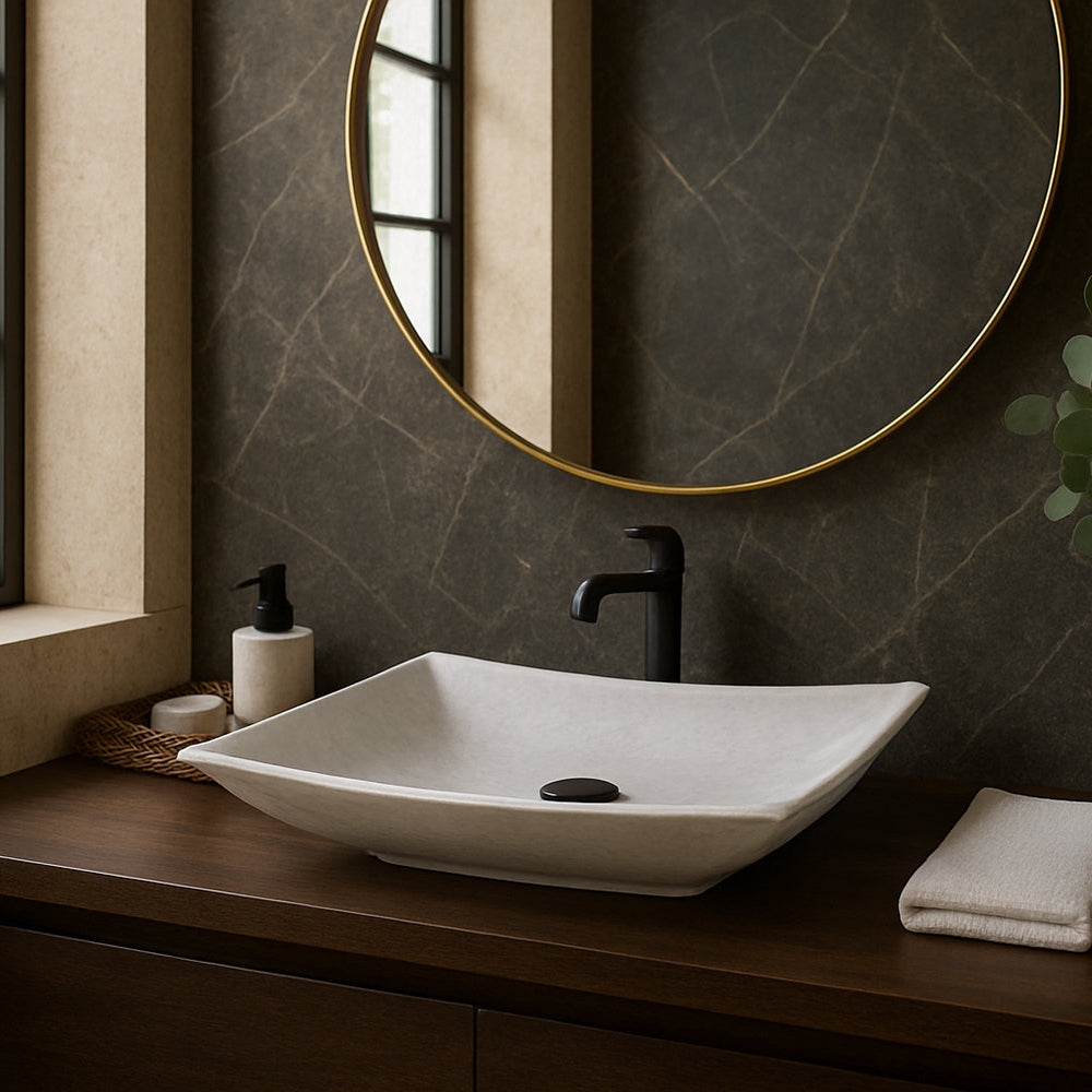 Bathroom vanity with a white sink, black faucet, and decorative elements.