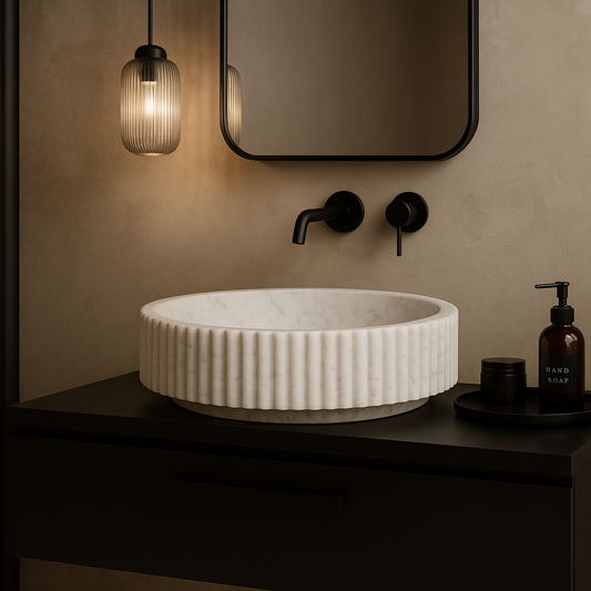 Bathroom vanity with a textured white sink, black fixtures, and a plant on a beige wall.